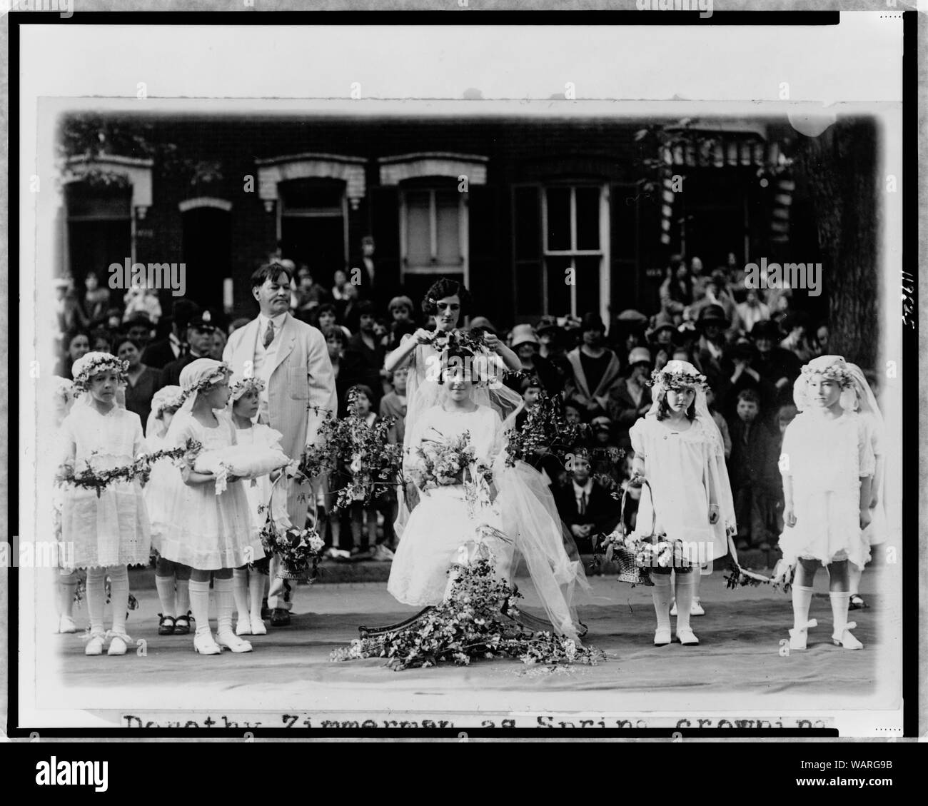 Dorothy Zimmerman, as Spring, crowning Irma Sweeney as the May Queen at the May Day festival at the Neighborhood House, Washington, D.C. Stock Photo