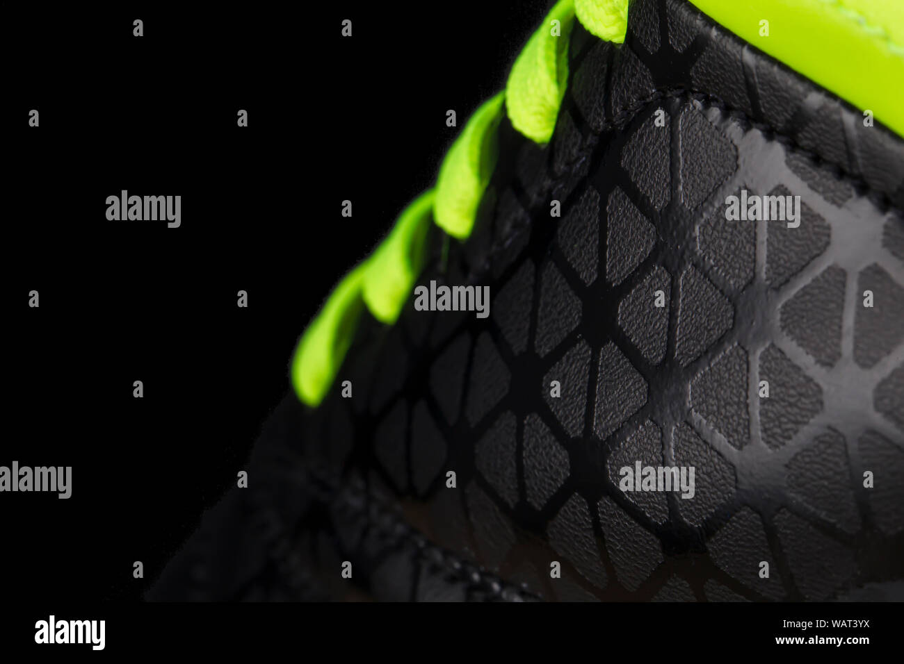 Fragment of black sneaker with green laces close up. Sneaker texture Stock Photo