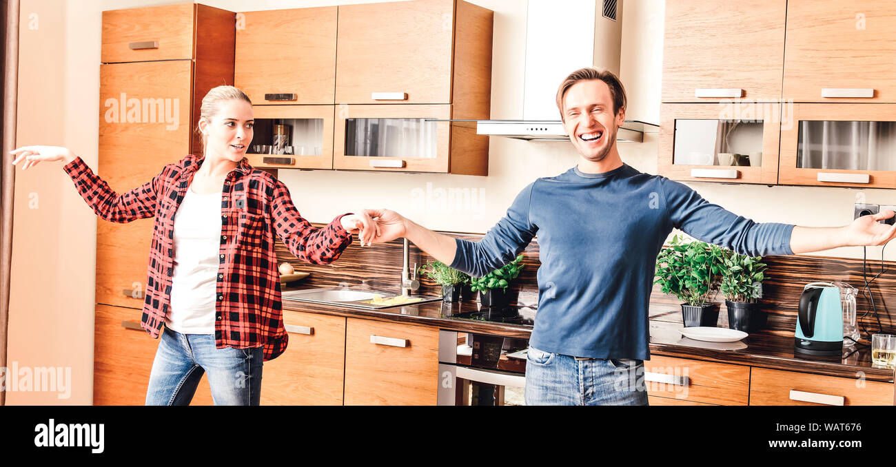 Lovers couple dancing in room. They having fun and celebrating movement to new home. Stock Photo