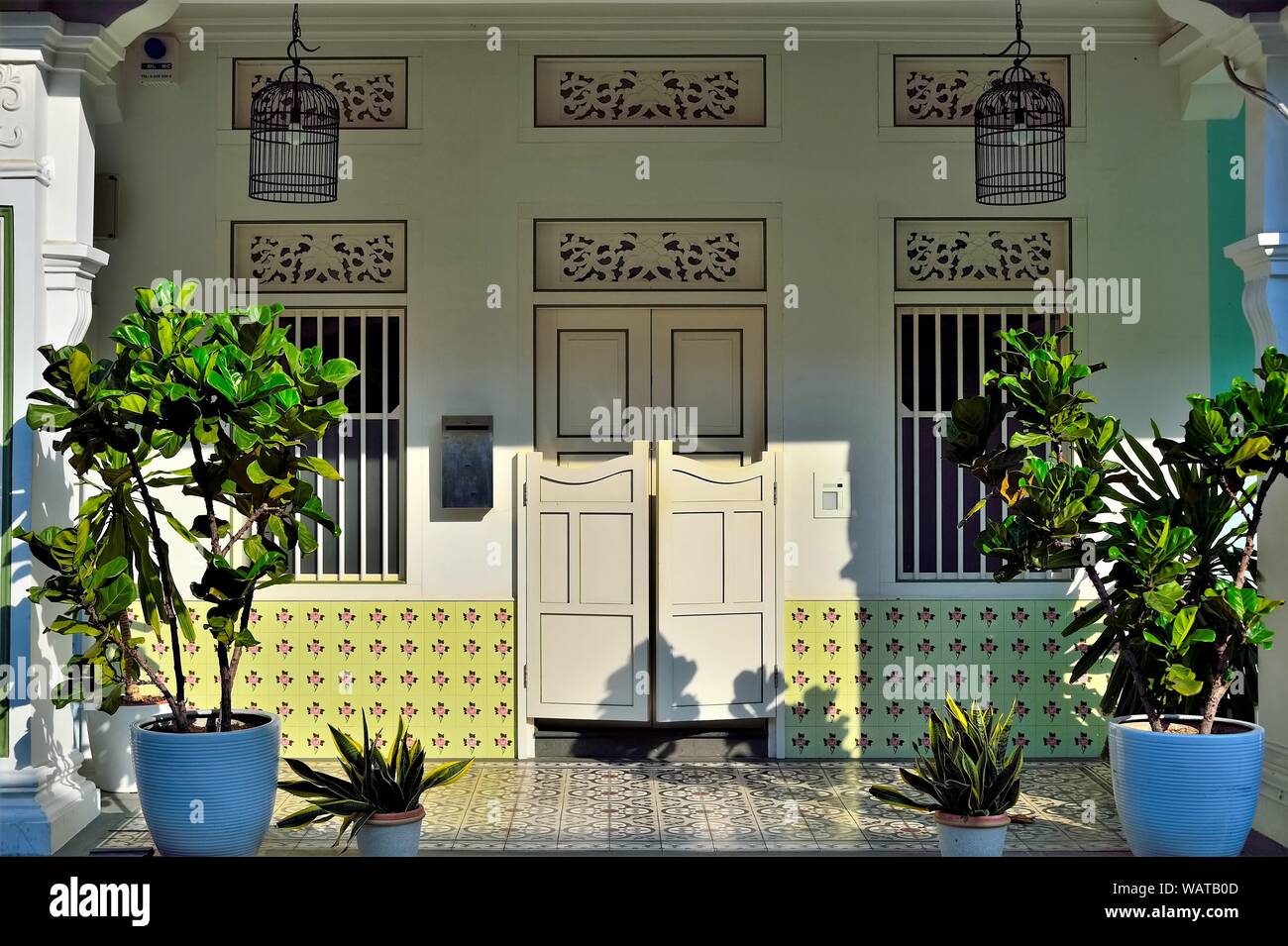 Colourful entrance to traditional Peranakan shop house with bifold doors, Chinese wall tiles historic Spottiswood Park, Singapore Stock Photo