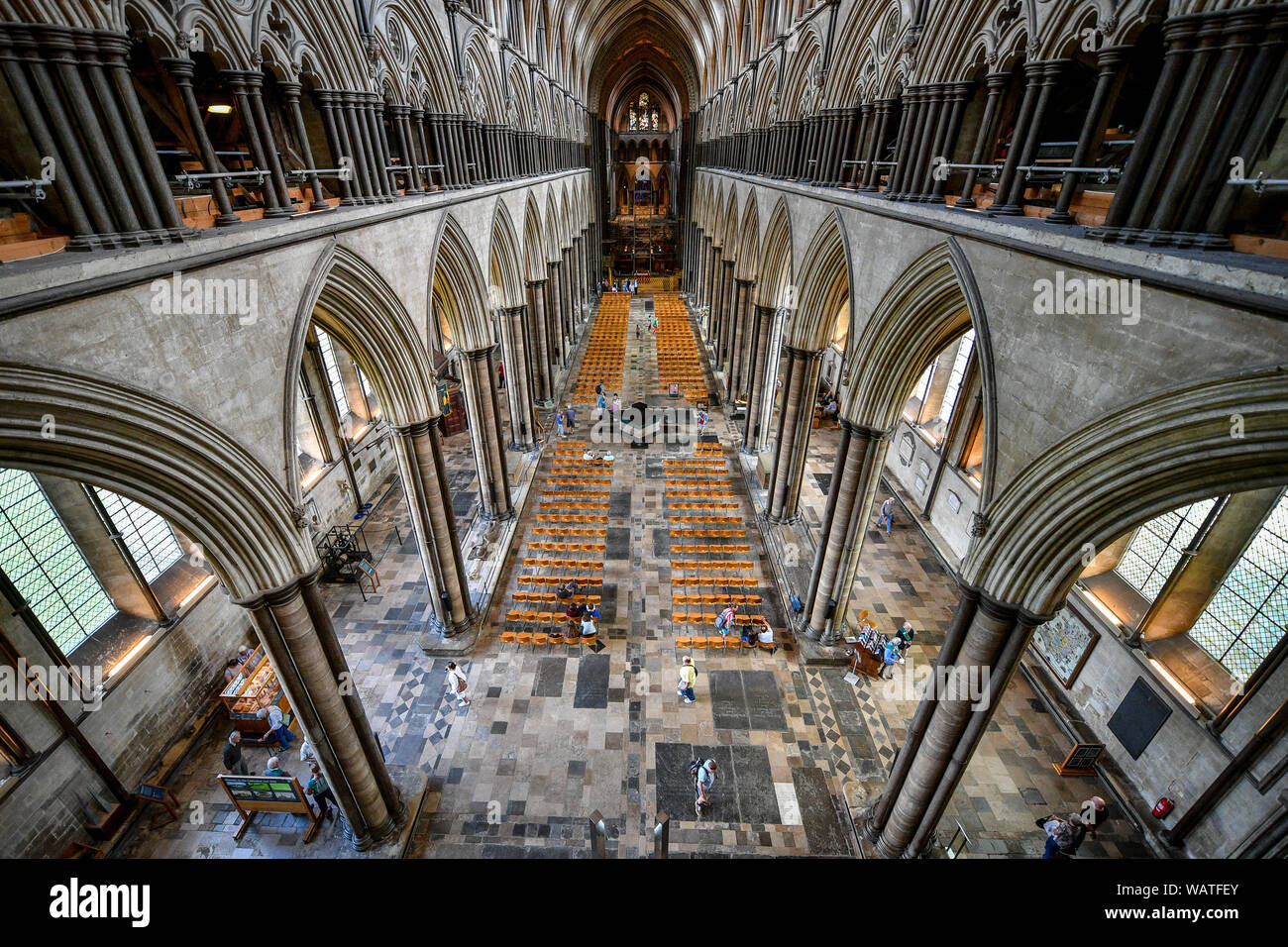 A view inside looking along the nave during the Salisbury Cathedral Tower Tour, where visitors are guided up to the base of the 123 metre tall spire, climbing 332 mainly spiral steps, through the vaulted roof space, past medieval stained glass and through the inner workings of the 13th century cathedral. Stock Photo