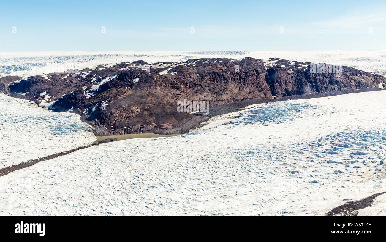 Greenlandic melting ice sheet glacier aerial view from the plane, near