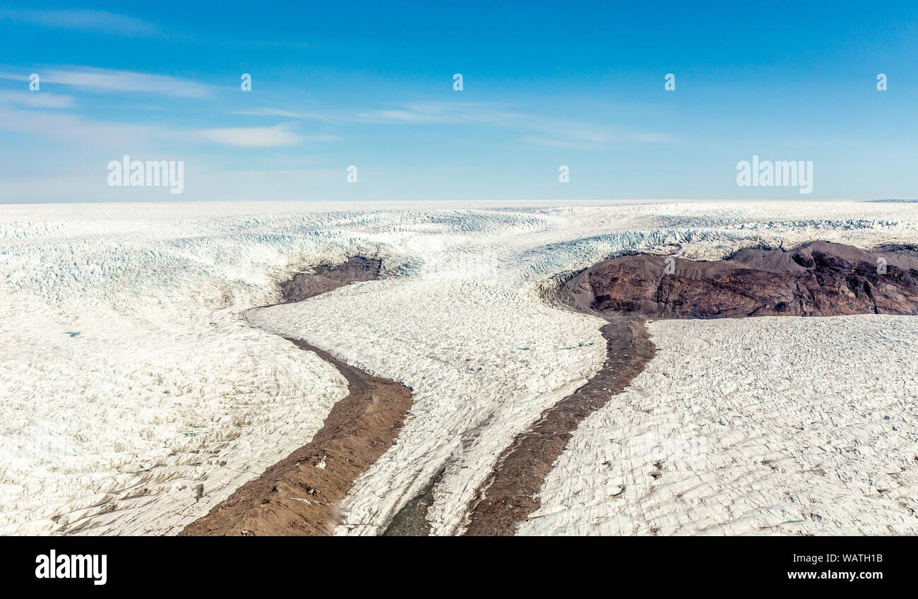 Greenlandic melting ice sheet glacier aerial view from the plane, near