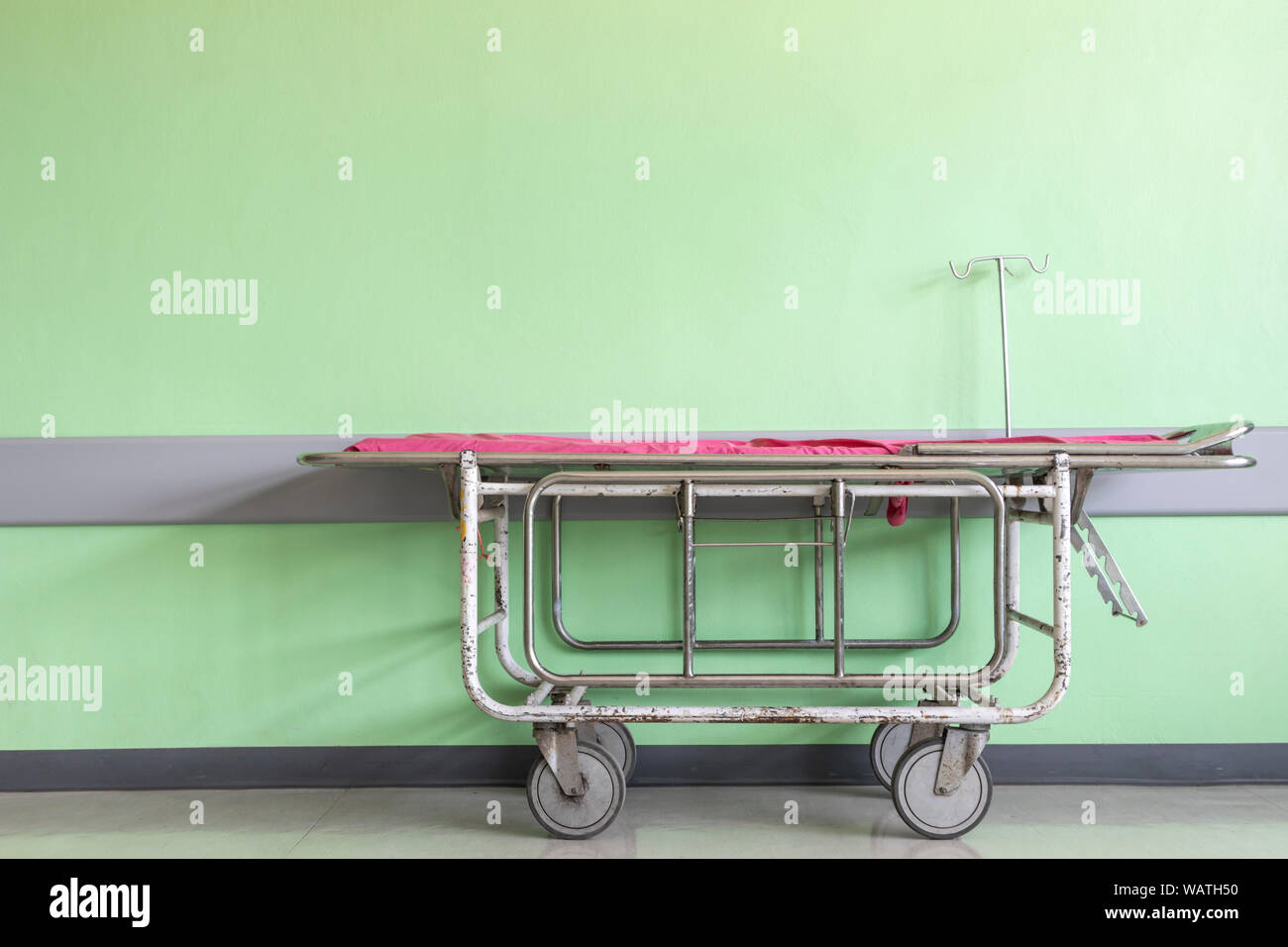 Empty patient stretchers and Gurneys beds on the side of the wall in hospital. Stock Photo