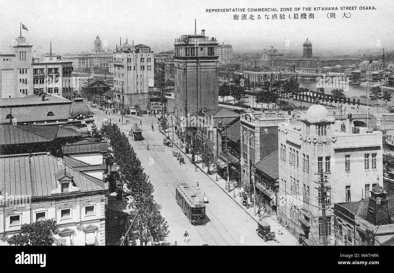 [ 1920s Japan - Business District in Osaka ] —   Osaka’s business district of Kitahama and the local government seat on Nakanoshima, an island sandwiched between the Dojima and Tosabori Rivers.   Osaka has already been thoroughly modernized. Two buildings with towers can be seen. The one on the right is the District Court. The other one Osaka City Hall.  The tall structure in the middle of the image is the Kitahama Building.  20th century vintage postcard. Stock Photo