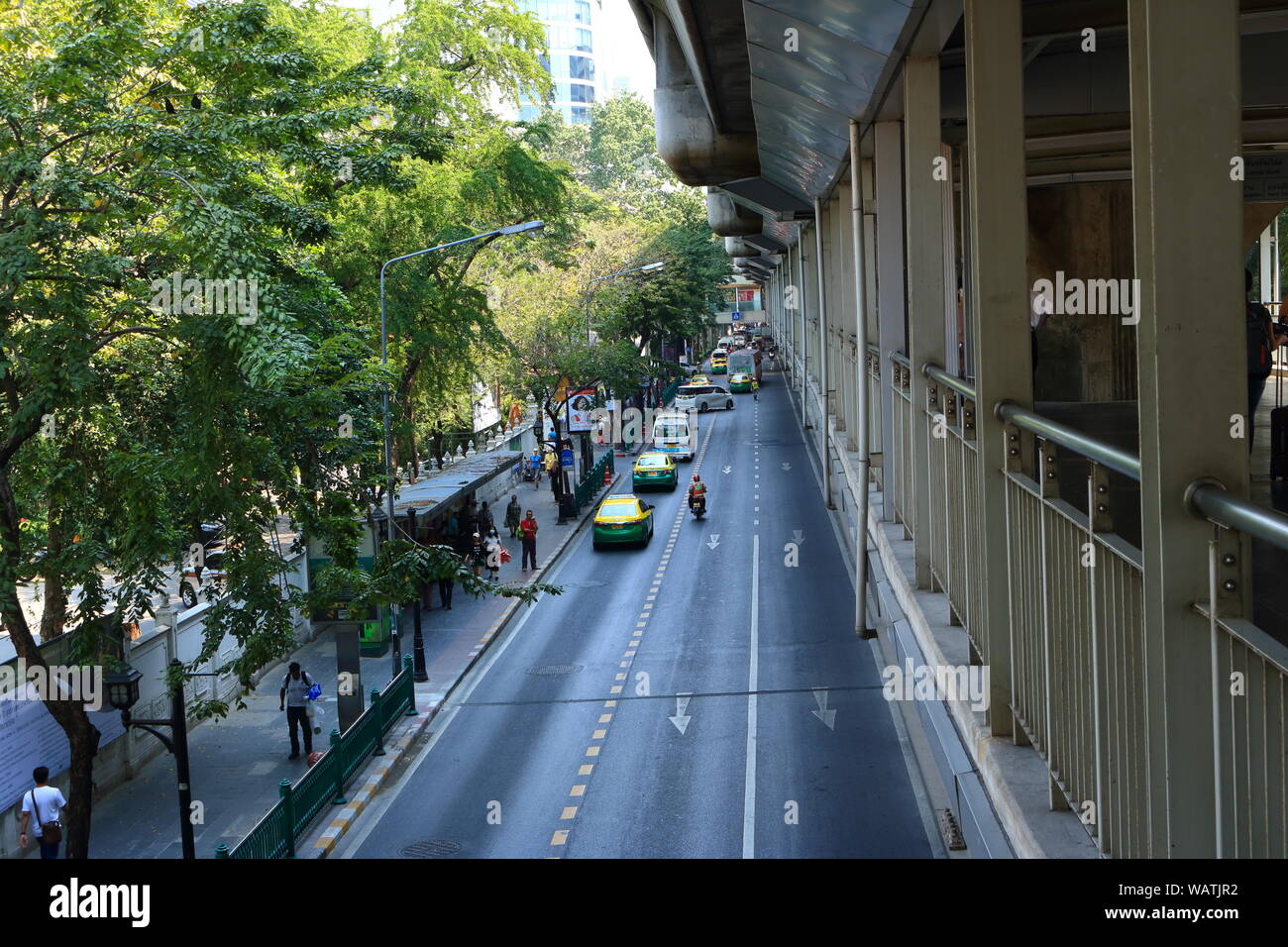 Diminishing perspective view of Rama 1 rd., in front of Pathumwanaram temple, looking from Siam square to Ratchaprasong intersection, business and sho Stock Photo