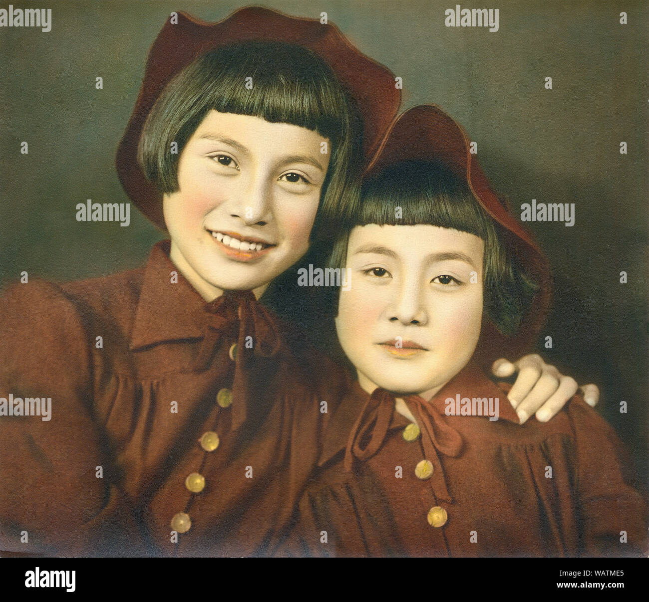 [ 1940s Japan - Two Japanese Sisters ] —   Two sisters. Hand tinted photograph of the late 1930s from the Hanaya Kanbei Studio in Ashiya, Hyogo Prefecture. The girls are actually this famed photographer’s daughters. Stock Photo