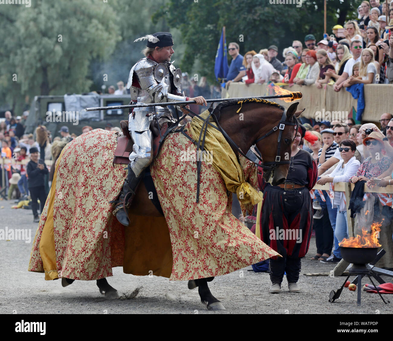 Hameenlinna Finland 08/17/2019 Medieval festival with craftsman, knights and entertainers. A parade with fire. A knight riding with his handsome horse Stock Photo
