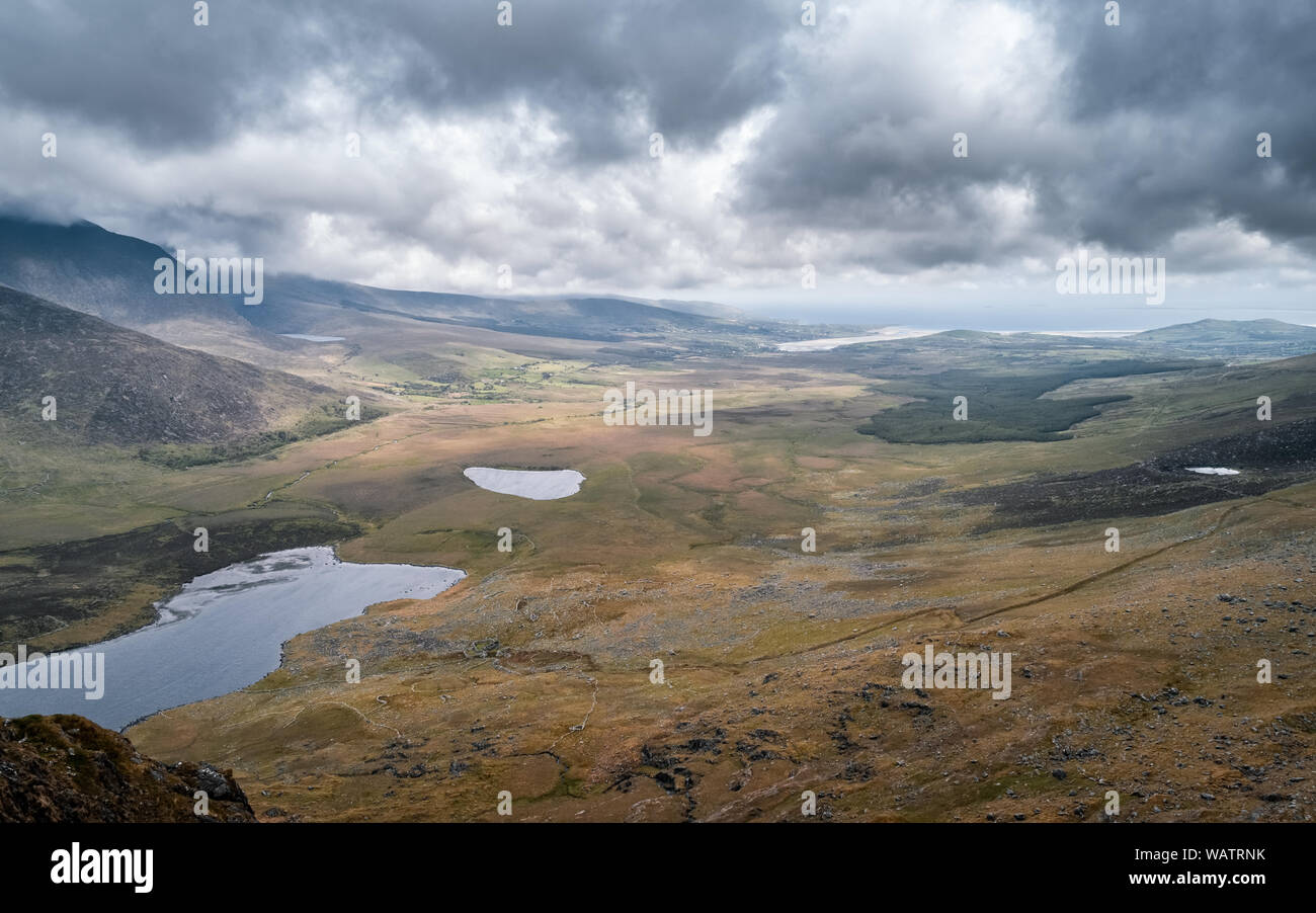 View over Clogharee Lough and Lough Atlea towards the Atlantic coast from Conor Pass in County Kerry in Ireland Stock Photo
