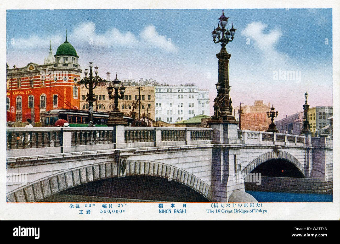 [ 1920s Japan - Nihonbashi Bridge, Tokyo ] —   Nihonbashi in Tokyo. During the Edo Period (1600-1867), the bridge was the starting point of the famous Tokaido and Japan's other 4 post roads. The stone bridge with bronze lions and wrought-iron gas lamps replaced the wooden one in 1911.  The red building is the Imperial Hemp Exchange Building; the white building in the middle the Mitsukoshi Department Store.  20th century vintage postcard. Stock Photo