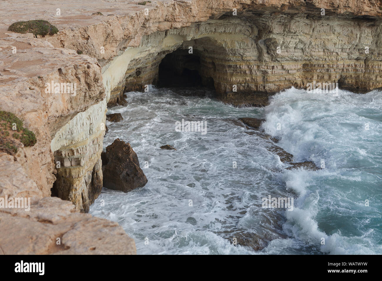 Rocky shore of Cyprus with waves crashing Stock Photo