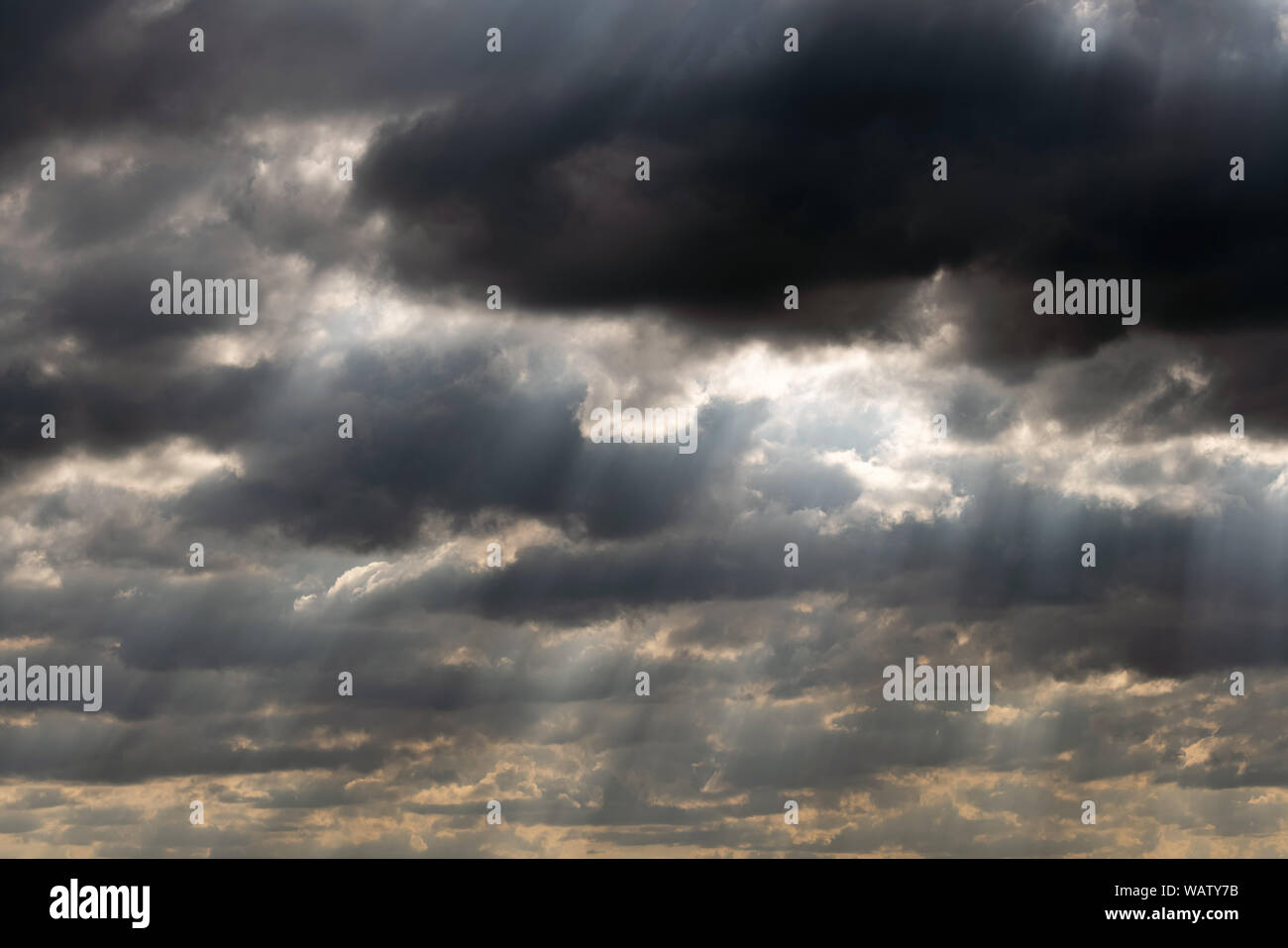 Dramatic sky panorama with sun rays between clouds. Idyllic sun beams cloudscape backdrop. Majestic cloud scenery Stock Photo
