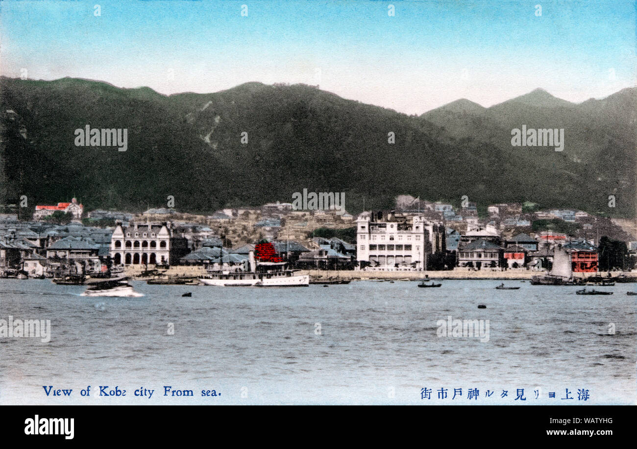 [ 1910s Japan - Kobe from the Sea ] —   View of Kobe city in Hyogo Prefecture as seen from the harbor, sometime between 1908 and 1918.   The big building on the right of the center is the Oriental Hotel (built in 1907).   The office buildings of the trading company Mitsui Bussan (built in 1918) and the famed shipping companies Nippon Yusen (built in 1918) and Osaka Shosen Kaisha (built in 1922) have not yet been built.  20th century vintage postcard. Stock Photo