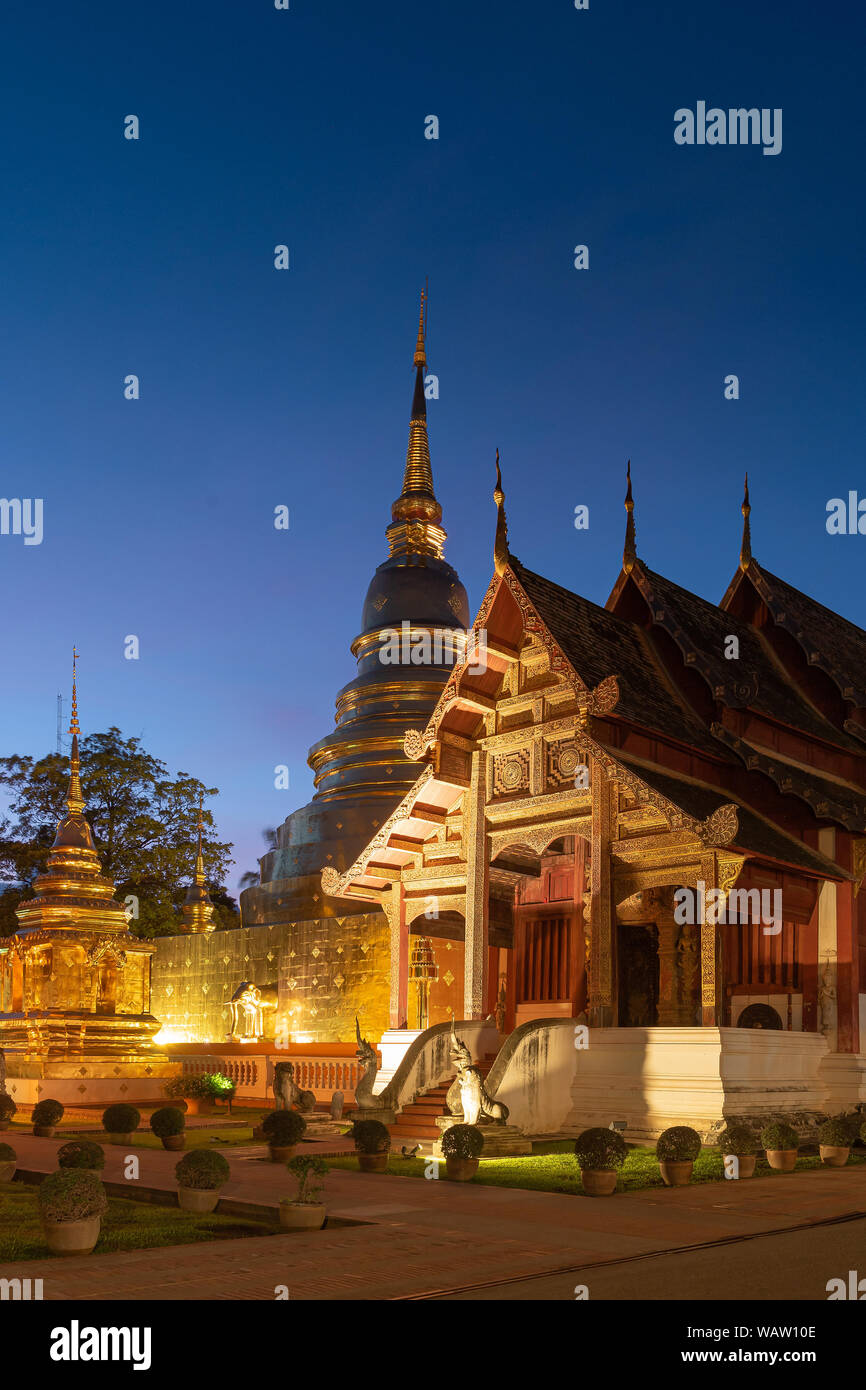 Wat Phra Singha chapel and pagoda lighting in evening. Chiang Mai, Thailand. Stock Photo