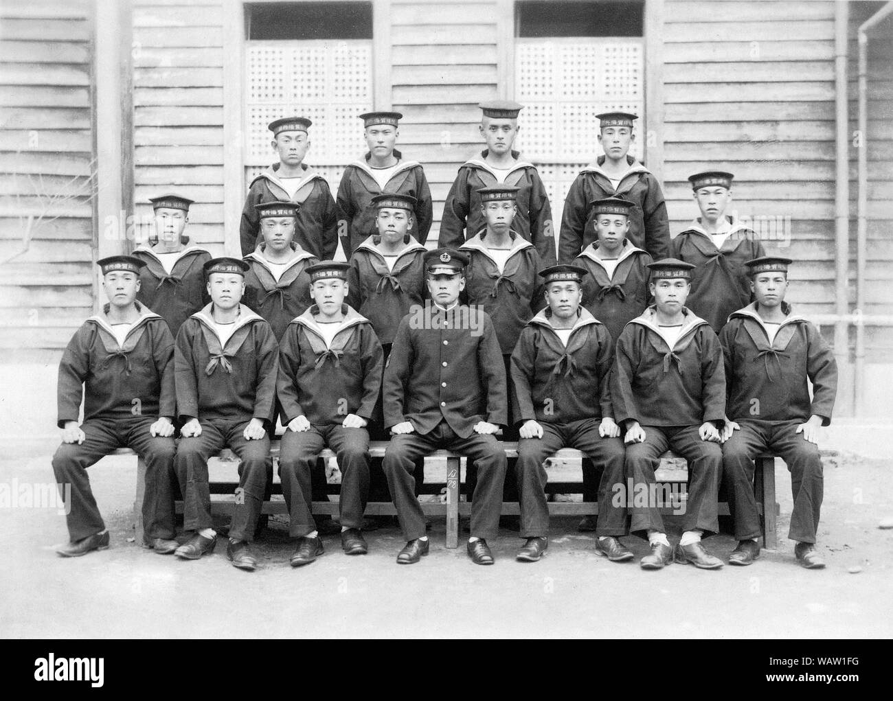 [ 1940s Japan - Japanese Navy Cadets ] —   Uniformed cadets and officer of the Imperial Japanese Navy in Yokosuka, Kanagawa.   Based on the insignia, this was photographed in November 1942 at the earliest.  20th century vintage gelatin silver print. Stock Photo