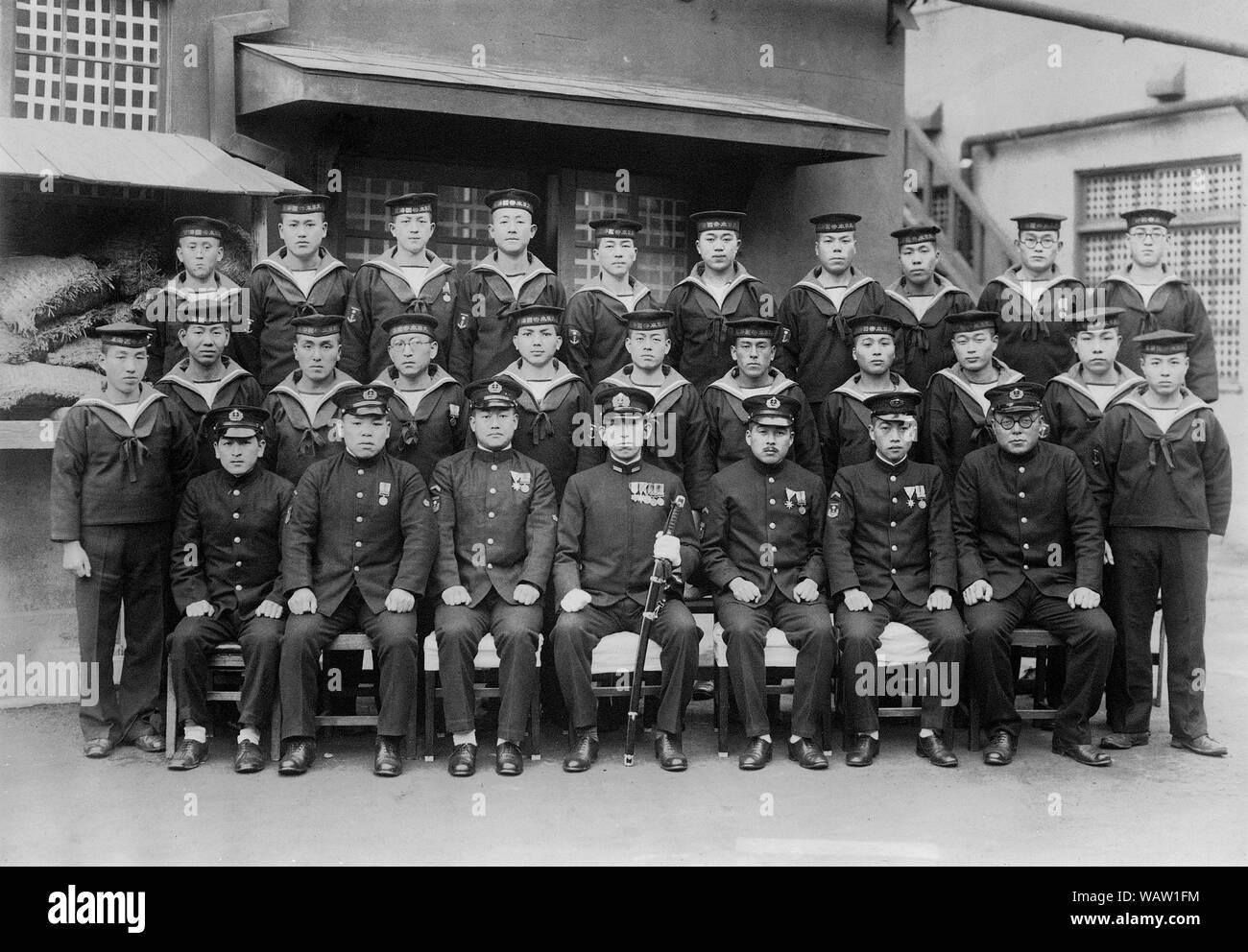 [ 1920s Japan - Japanese Navy Cadets ] —   Uniformed cadets and officers of the Imperial Japanese Navy in Yokosuka, Kanagawa.  Based on the insignia, this was photographed in November 1942 at the earliest.  20th century vintage gelatin silver print. Stock Photo