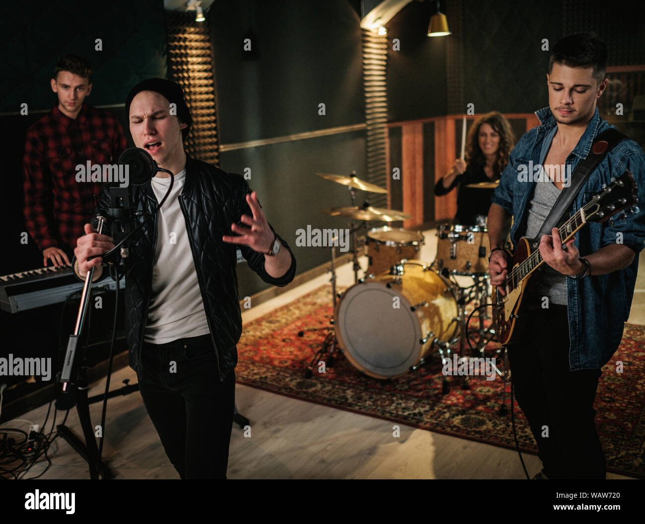 Music band having rehearsal in a studio Stock Photo - Alamy