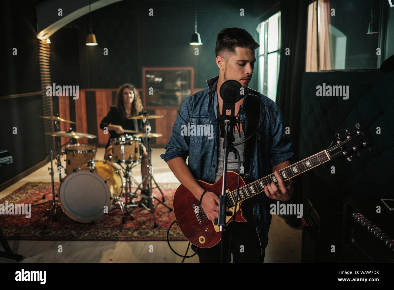 Music band having rehearsal in a studio Stock Photo - Alamy