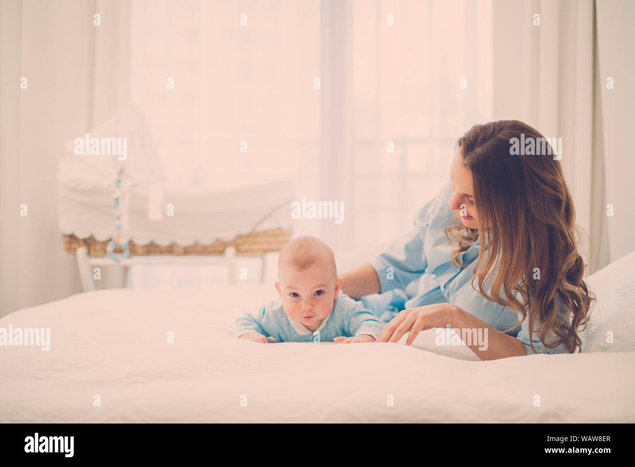 Beautiful middle aged mother with her child in a bed Stock Photo Alamy