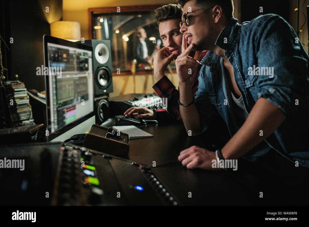 Sound engineer working in a music studio Stock Photo - Alamy