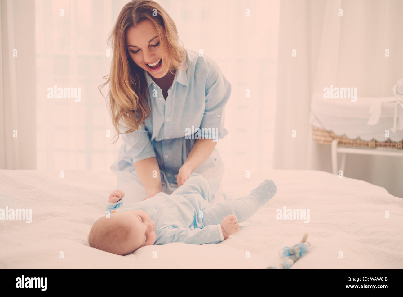 Beautiful middle aged mother with her child in a bed Stock Photo Alamy
