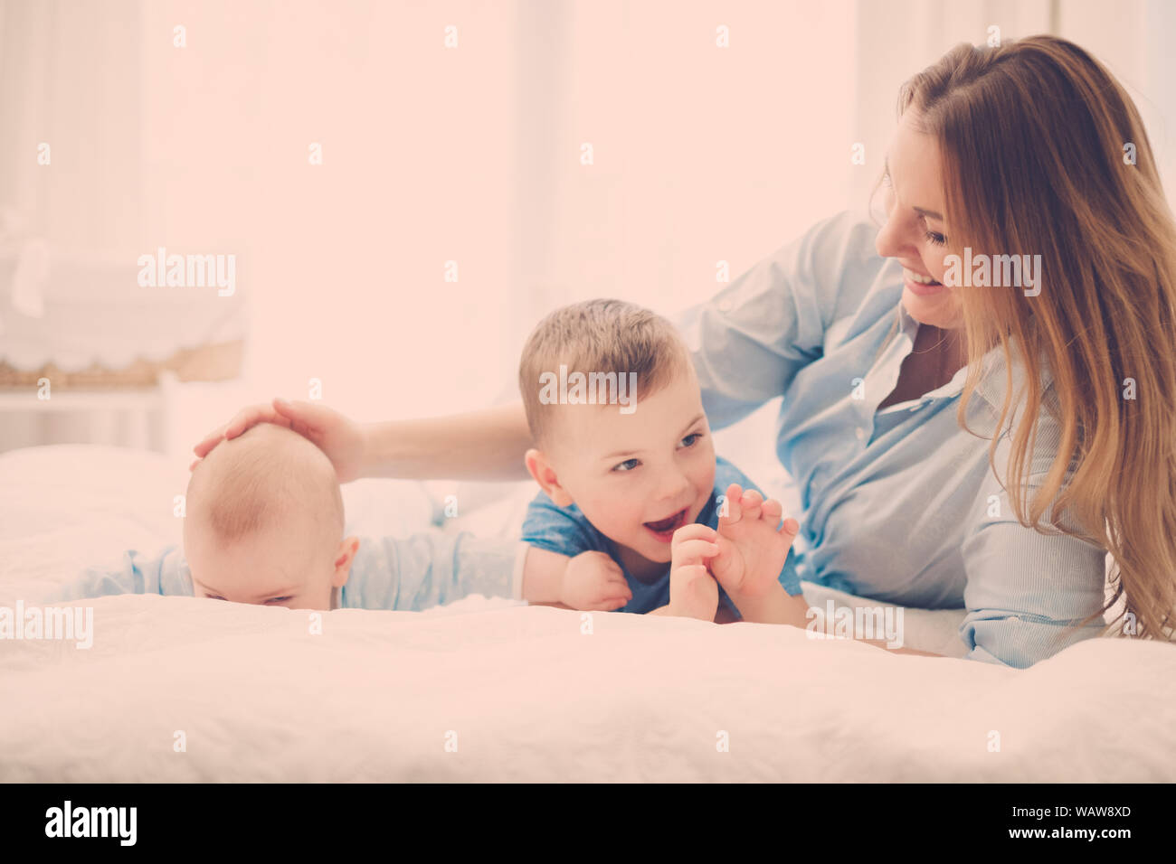 Beautiful middle aged mother with her child in a bed Stock Photo Alamy