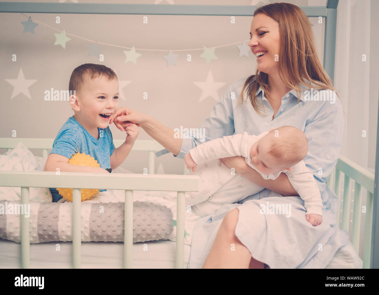 Beautiful middle aged mother with her child in a bed Stock Photo Alamy