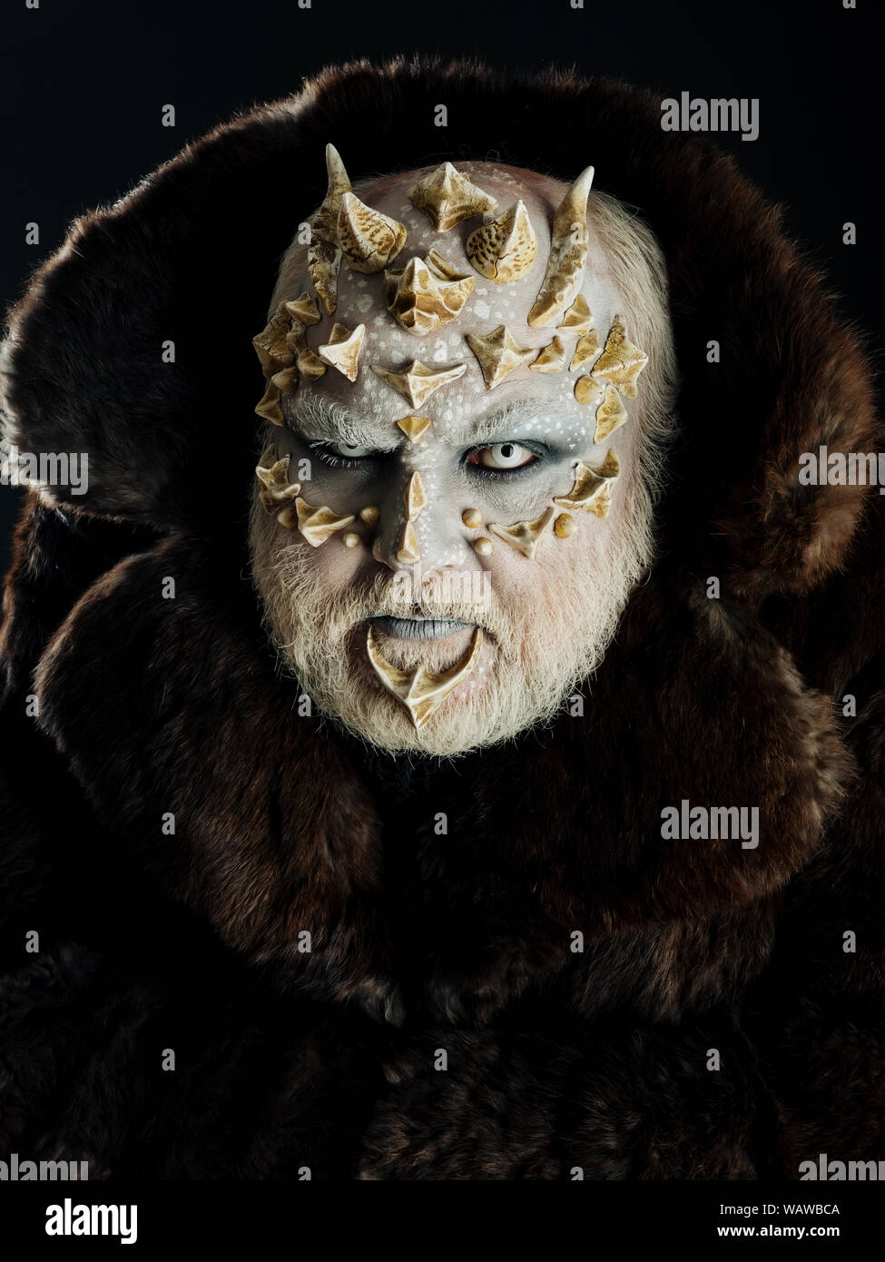 Man With Dragon Skin And Grey Beard Monster With Sharp Thorns And Warts On Face Demon In Fur Coat On Black Background Alien Or Reptilian Makeup Ho Stock Photo Alamy