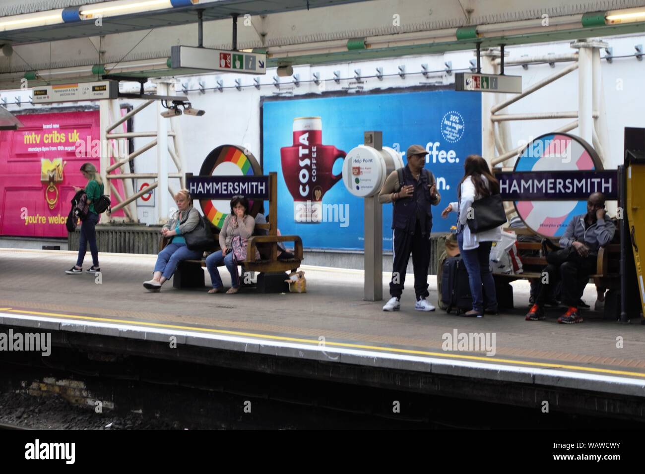 Travellers are waiting for a train at Hammersmith tube station, London