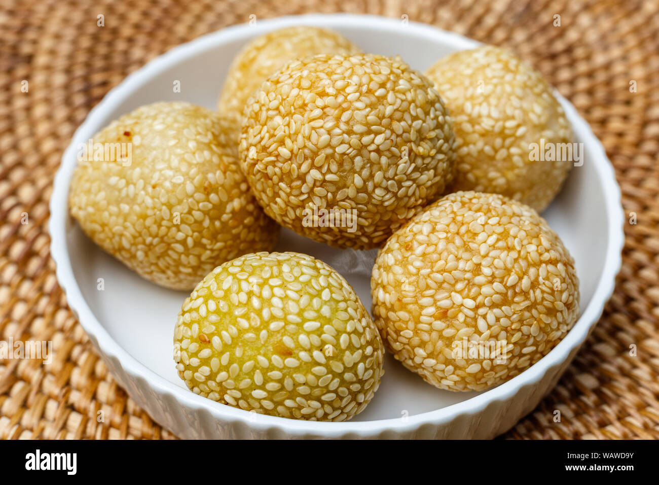 Onde-onde (ondhe-ondhe), rice flower balls coated in sesame seeds with green bean powder or black sticky rice inside. Traditional Indonesian dessert. Stock Photo