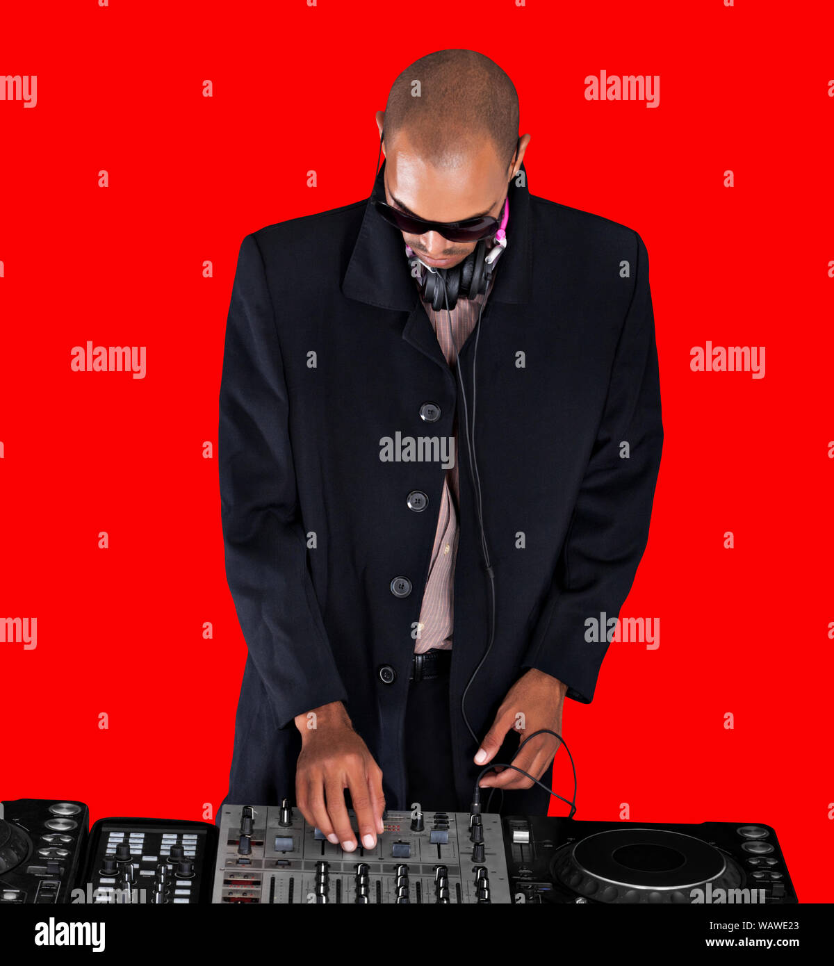 African musician singer turning knobs at the turntable of a  DJ music system Stock Photo