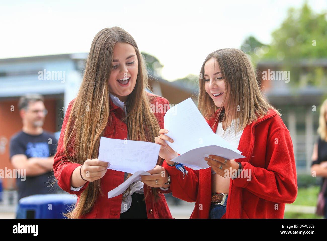 GCSE Exam results day. Two girl students with their results letters