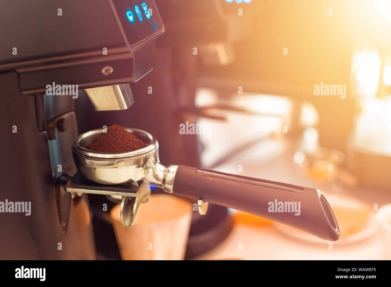 Barista grinding coffee ready for perfect cup of espresso in coffee shop Stock Photo