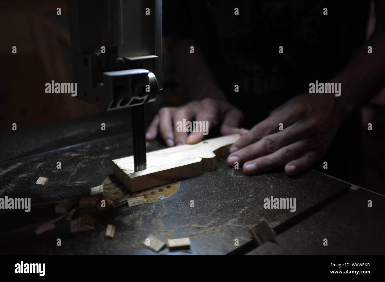 Carpenter builder working with electric jigsaw and wood. Woodworker cutting a piece of wood Stock Photo