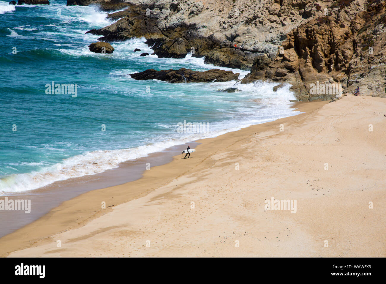 A surfer on the coast of northern California between Sasn Francisco and Monterrey. Stock Photo