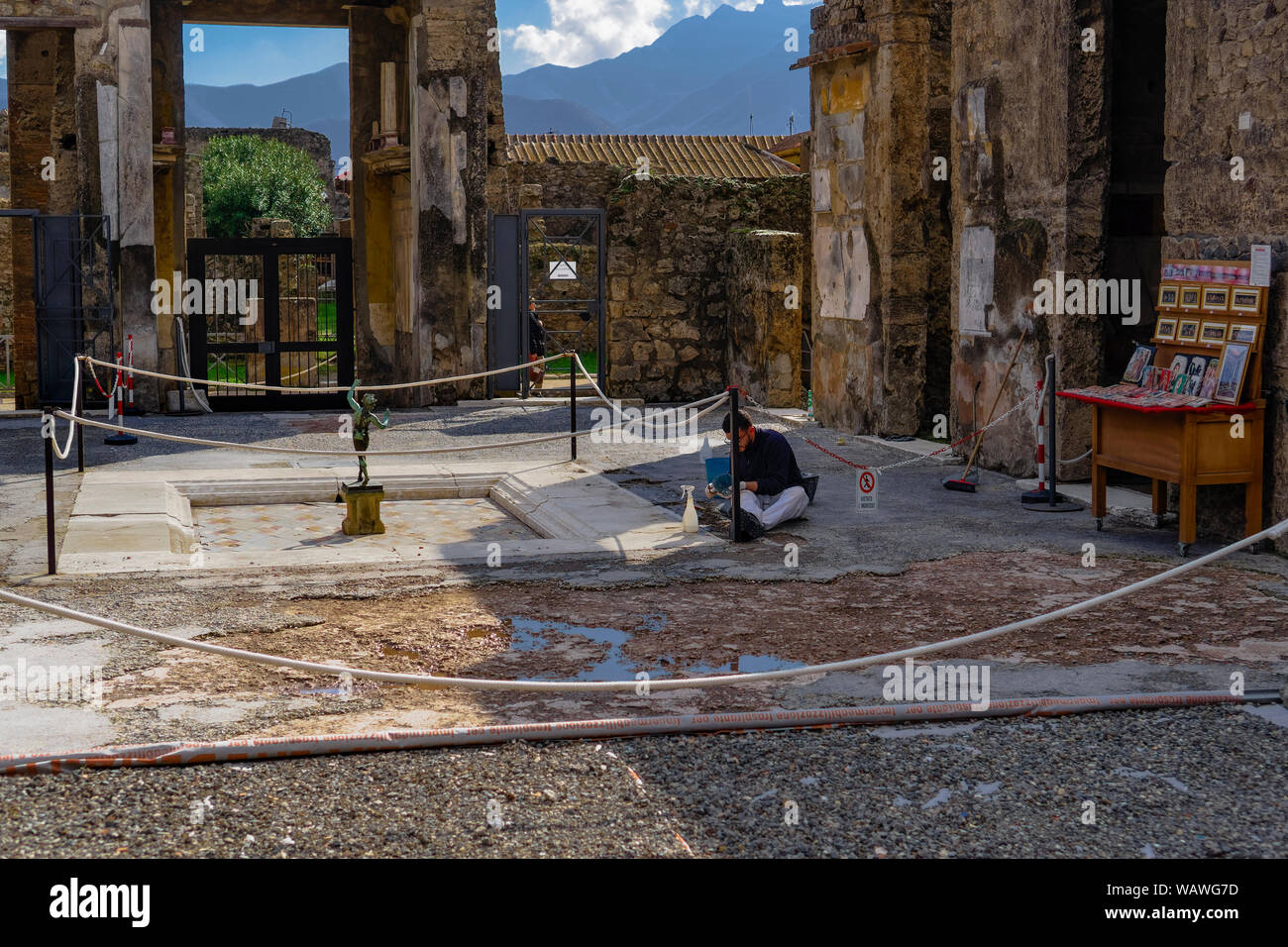 Pompeii Italy Restoration Project On Excavations To Preserve Remains Worker During Restoration By Ruins Of Casa Del Fauno With Replica Bronze Statue Stock Photo Alamy