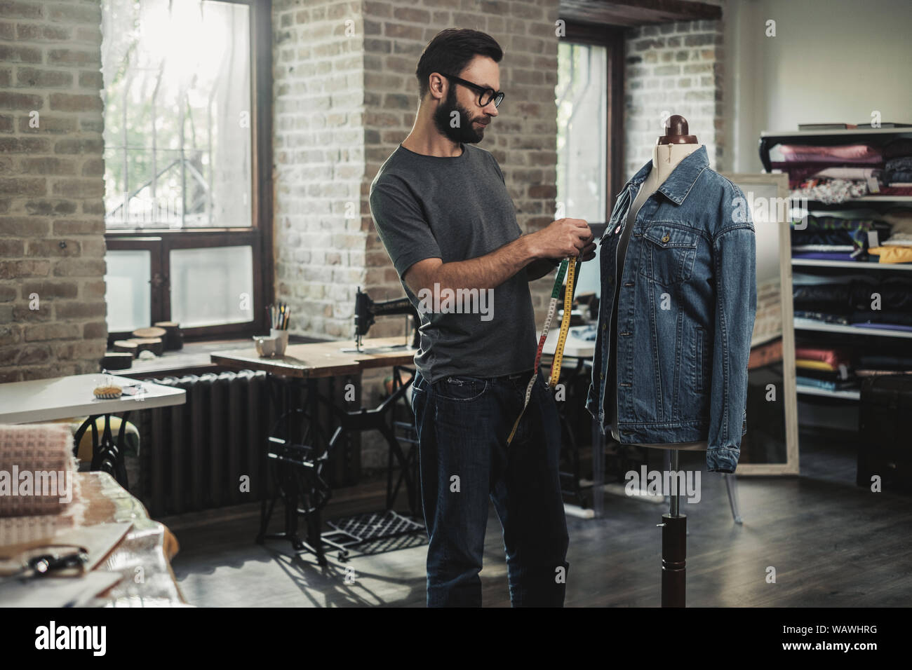 Fashion designer working in his studio Stock Photo - Alamy