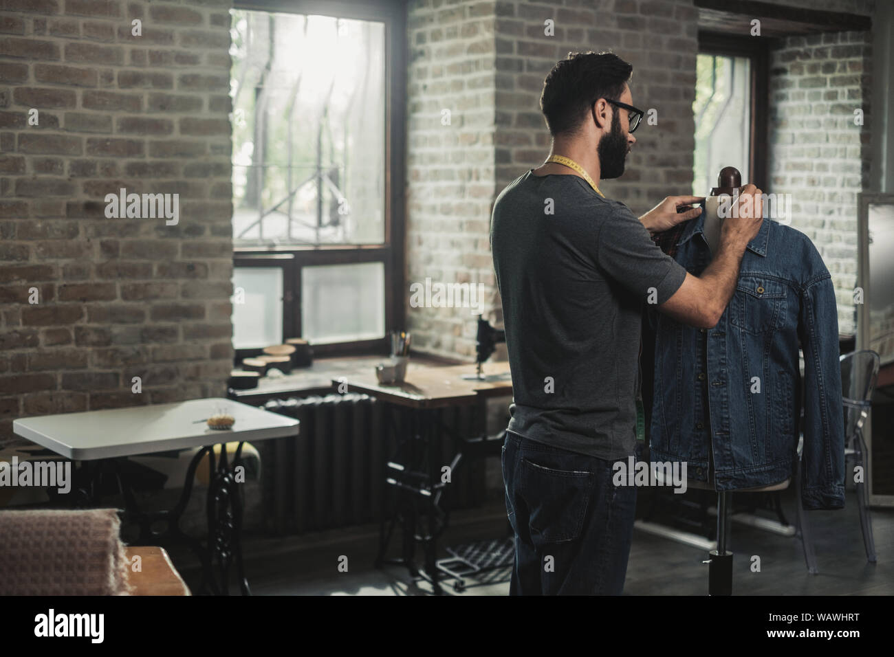 Fashion designer working in his studio Stock Photo - Alamy