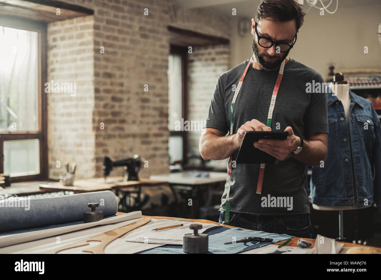 Fashion designer working in his studio Stock Photo - Alamy