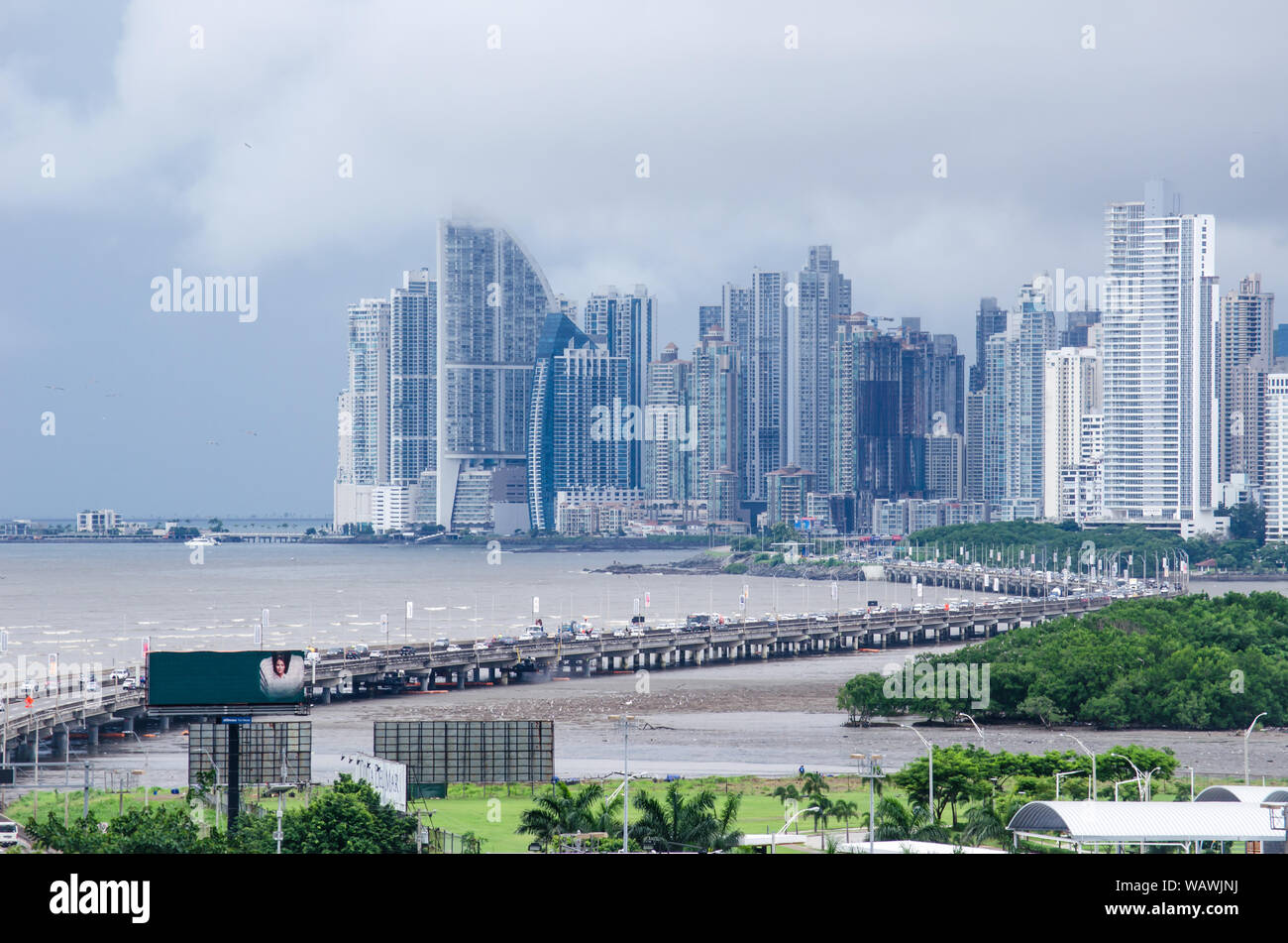 Panama City skyline as seen from Costa del Este neighborhood. The South Corridor that connects the city centre with tocumen airport is also seen. Stock Photo