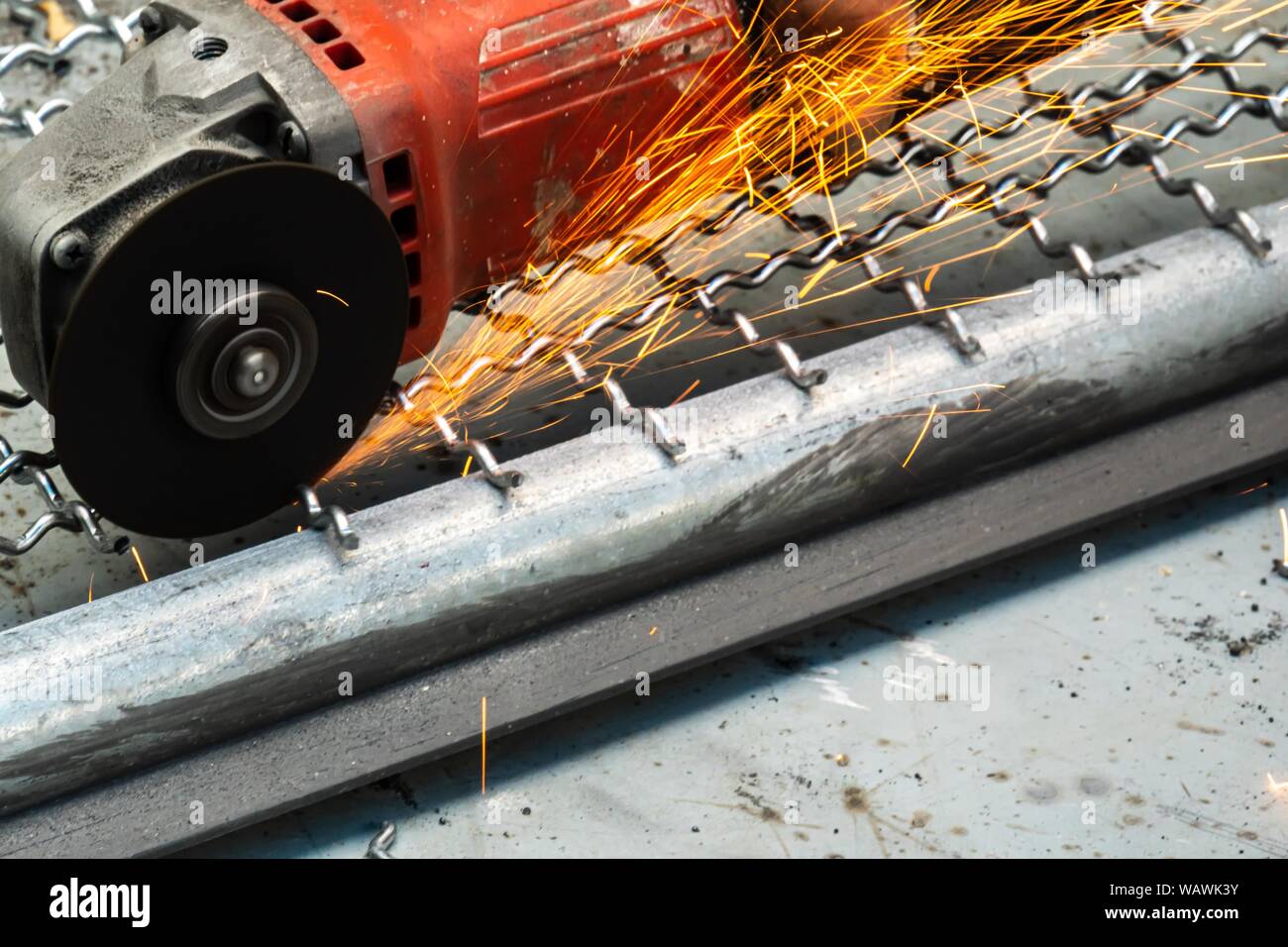 man used angle grinder without cover guard cutting metal net to make
