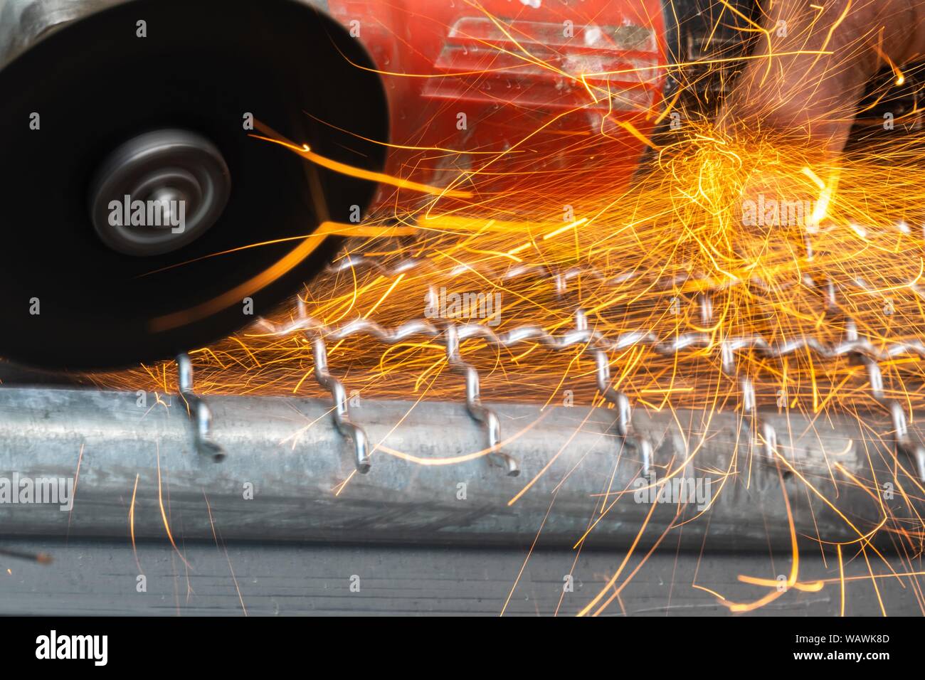 man used angle grinder without cover guard cutting metal net to make