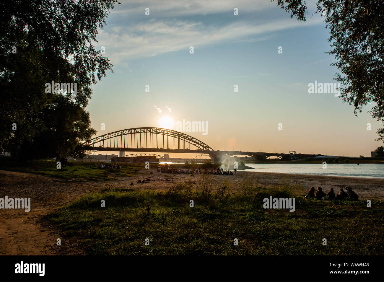 Nijmegen, Gelderland, Netherlands. 21st Aug, 2019. View of the Waalbrug bridge during sunset.The Ooijpolder is a beautiful area for walking and recreation close to the Waalbrug Bridge and surrounded by the Waal River. The area is located east of the city of Nijmegen in the province of Gelderland. Credit: Ana Fernandez/SOPA Images/ZUMA Wire/Alamy Live News Stock Photo