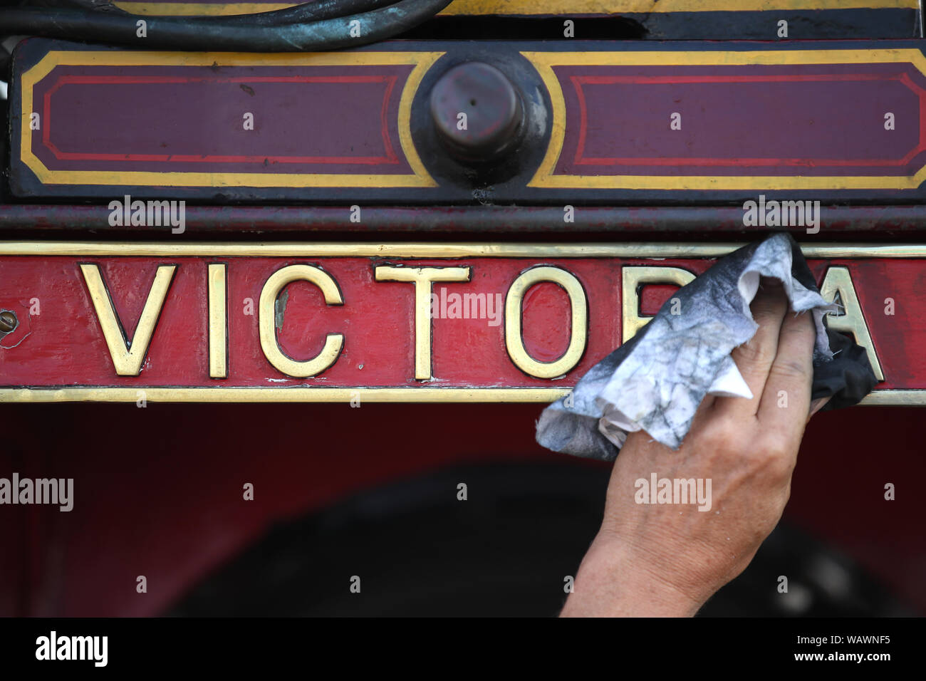 A locomotive sign is cleaned during day one of the 2019 Great Dorset Steam Fair. The fair is a gathering of hundreds of period steam traction engines and heavy mechanical equipment from all eras come to showcase Great Britain's rich industrial, agricultural and leisure history, at the annual show taking place over the August Bank Holiday weekend from Thursday 22nd to Monday 26th August. Stock Photo