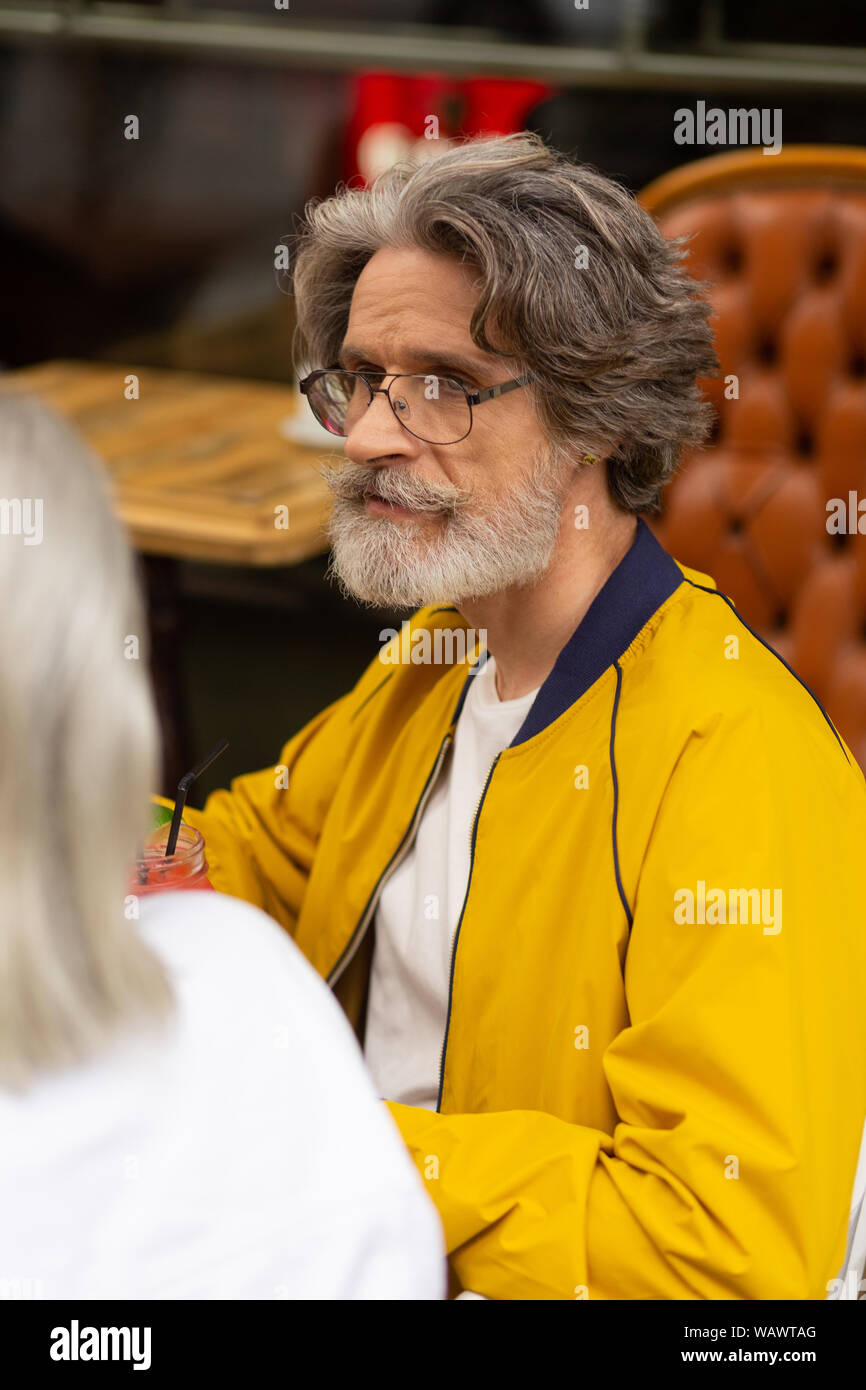 Thoughtful man drinking smoothie with his wife. Stock Photo
