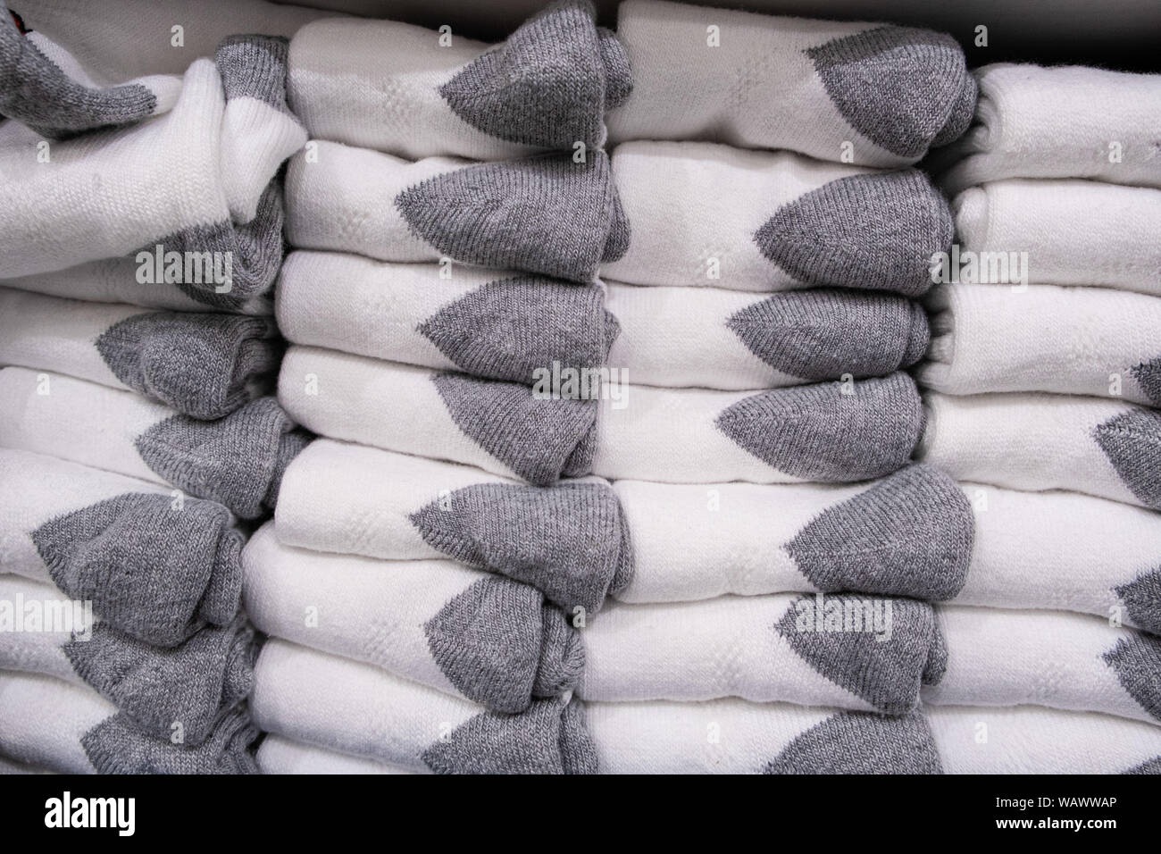 Stack of folded white socks with gray ankles closeup Stock Photo
