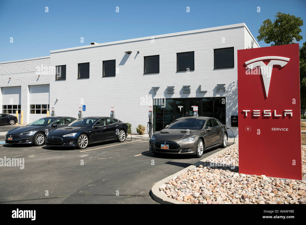 A logo sign outside of a Tesla car dealership in Salt Lake City, Utah on July 28, 2019. Stock Photo