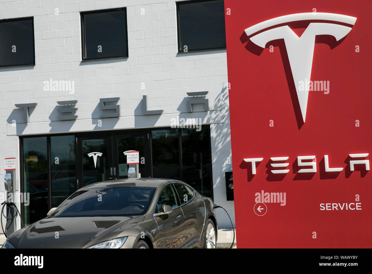A logo sign outside of a Tesla car dealership in Salt Lake City, Utah on July 28, 2019. Stock Photo