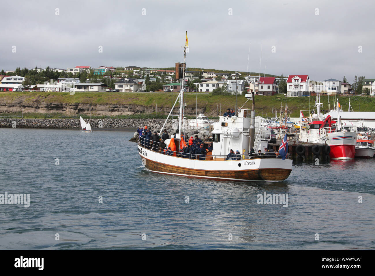 Whale watching boat leaving Husavik harbour Stock Photo - Alamy