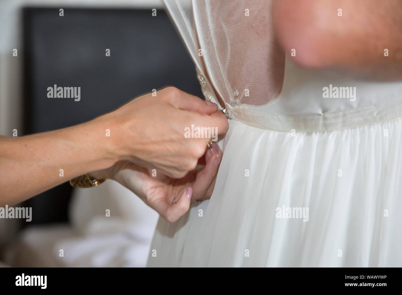 wedding dress close up, wedding dress being done up on  the brides wedding day, right before the wedding ceremony Stock Photo